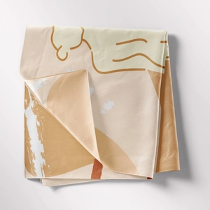Detail shot of folded bohemian tapestry showing abstract geometric patterns and soft texture
