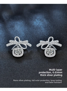 Macro view of 925 sterling silver bow earrings with sparkling moissanite center stones