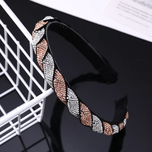 Detailed view of rhinestone headband featuring wave pattern crystals and non-slip inner teeth