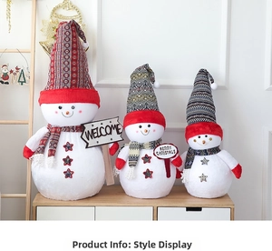 Three plush Christmas snowmen in various sizes with woven hats on a wooden surface