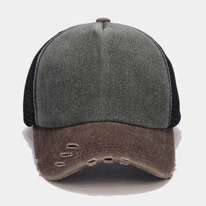 Detail of distressed brim and breathable mesh on vintage washed trucker baseball cap