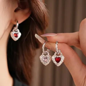 Elegant silver textured heart drop earrings with faceted red stone and hook design