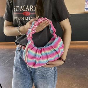 Detail of colorful rainbow pleated shoulder bag with soft textured fabric and crescent shape