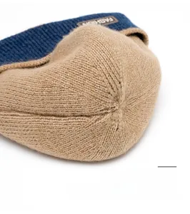 Detailed macro view of the sturdy thick knit stitching and color-block top of the beanie