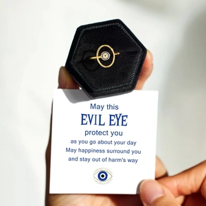 Golden S925 silver evil eye ring presented in a velvet gift box with a blessing card
