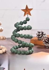 Front detail of green wooden beaded spiral Christmas tree with a rustic star topper