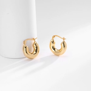 Detail of S925 sterling silver stamp on chunky gold plated U-shaped hoop earrings