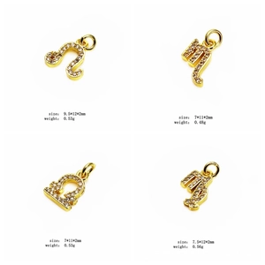 Macro view of gold zodiac charms with cubic zirconia showing precise size and weight data