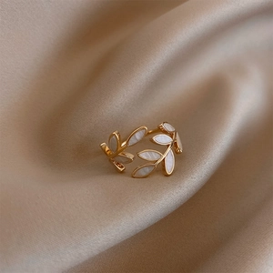 Elegant gold leaf open ring for women featuring white shell inlay on champagne silk background