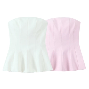 Close-up of white and pink strapless peplum tops showing textured fabric details