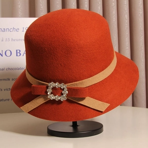 Gros plan d'un chapeau cloche en laine avec ruban et boucle en strass scintillants