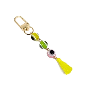 Turkish resin eye keychain with colorful beads and yellow tassel on white background