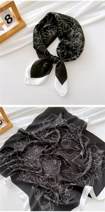 Detailed view of 70cm square silk scarf with white abstract line patterns on black