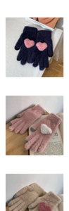 Detail of knit winter gloves with heart patterns and conductive touch screen fingertips
