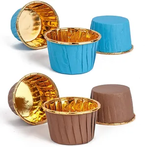 Detail of blue and brown cupcake liners with shiny gold metallic inner foil lining