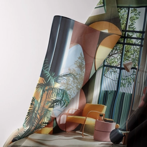 Detail of artistic bohemian tapestry featuring a modern yellow chair and green plants