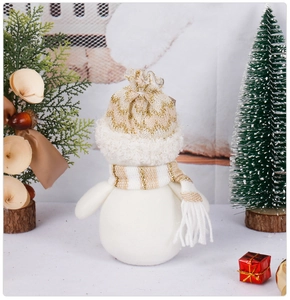 Detailed view of a plush Christmas snowman with gold-knit hat and scarf decor