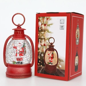 Christmas LED lantern with Santa Claus figurine and snowy glitter in festive red gift box