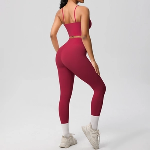 Detail view of red double-sided brushed yoga set showing cross back straps and high waist fit