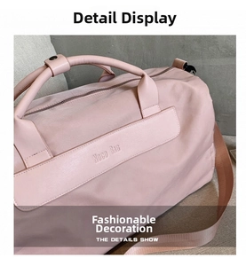 Detailed view of pale pink gym bag featuring brand logo and reinforced leather handles