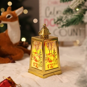 Close-up of golden Christmas lantern with Santa pattern and warm LED light decoration