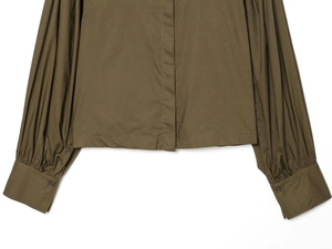 Detailed view of puff sleeve poplin shirt cuffs and hem in dark olive green