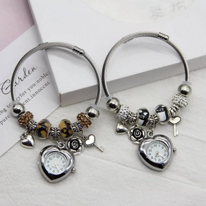 Detail of beaded flower bracelet watches with heart pendants and crystal accents