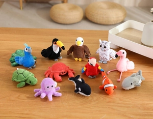 Detailed set of 12 colorful plush ocean and bird finger puppets on a wooden surface