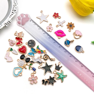 Assorted DIY colorful enamel alloy charms featuring hearts and stars on a white tray