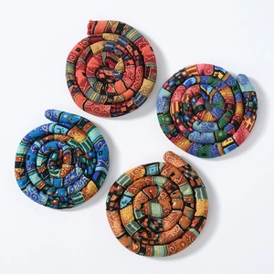 Detail view of ethnic style fabric bendable hair ties with colorful woven patterns
