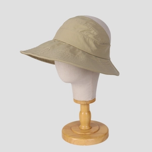 Detail of a khaki wide-brim sun hat featuring durable stitching and breathable fabric