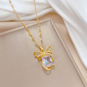 Luxury bow ribbon necklace with a large rectangular crystal in polished titanium steel