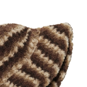 Close-up of plush brown and beige checkerboard pattern faux fur fabric texture