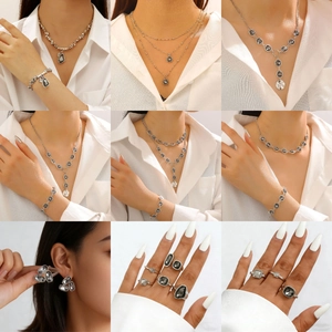 Irregular acrylic black gemstone necklace bracelet ring set worn by a model