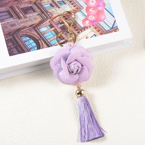 Elegant purple PU leather rose flower keychain with matching tassel and gold-toned metal clasp