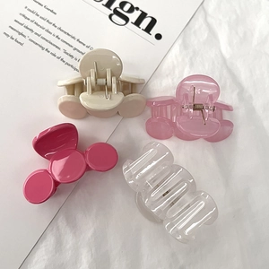 Pink and beige medium hair claw clips set on white fabric for elegant styling