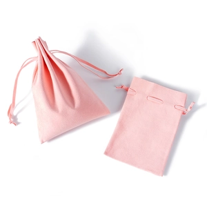 Pink velvet microfiber drawstring pouch for jewelry and watch storage on white background