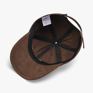 Brown cotton baseball cap with interior cross-stitch design and adjustable metal buckle