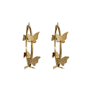Golden butterfly hoop earrings with a textured matte finish on a clean white background