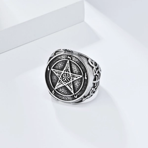 Macro shot of gothic stainless steel ring with pentagram and occult star engravings