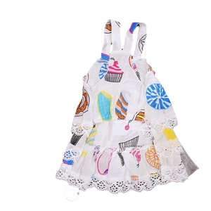 Detail of white pet dress with colorful dessert prints and delicate lace edging