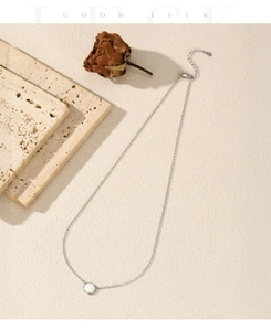 Detail of S925 sterling silver necklace with synthetic opal pendant on a textured surface