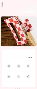 Detail view of pink and white checkered hair claw clip with a hollow rectangular design