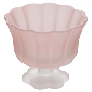 Pink frosted glass cup with white petal base for juice and yogurt on white background