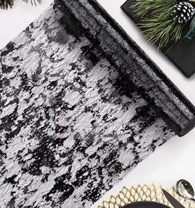 Detailed black lace table runner with gold foil marbling for elegant festive table setting