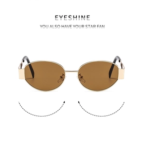 Detailed view of oval gold metal sunglasses frame with premium brown lenses