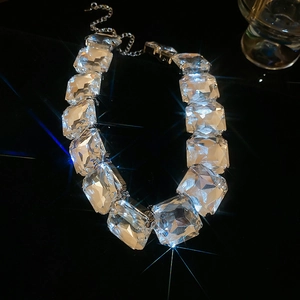 Detail of luxury necklace with large square faceted crystal stones and silver clasp
