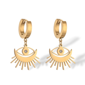 Macro shot of gold-plated evil eye hoop earrings with radiant lines and clear gemstone