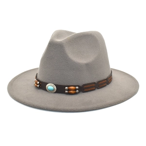 Detail view of light grey wool fedora hat with turquoise stone and brown leather band