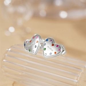 Macro shot of 925 silver heart stud earrings featuring colorful stones and mama engraving